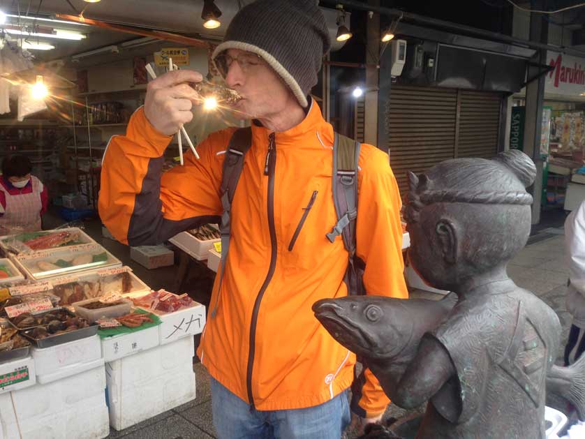 Eating fresh raw oysters at Sapporo Fish Market.