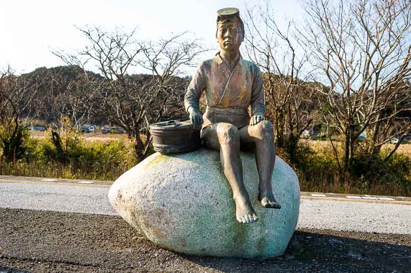 Ama-san female abalone diver statue on the platform of Onjuku Station.