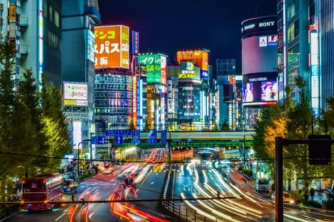 Neon signs of shops on a large road in Shinjuku