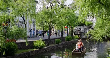 Tourists take a boat trip to Kurashiki.